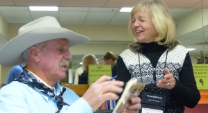 Cowboy Poet Fred Engel autographs his book for Lynn Snyder